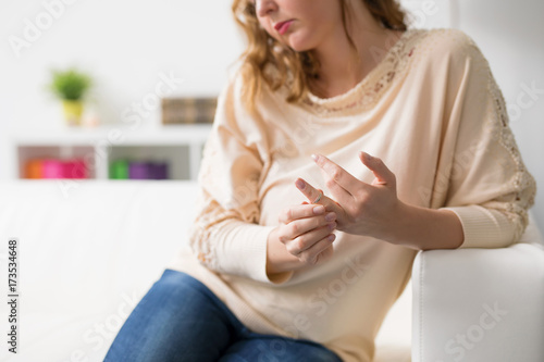 Woman in divorce taking off her wedding ring