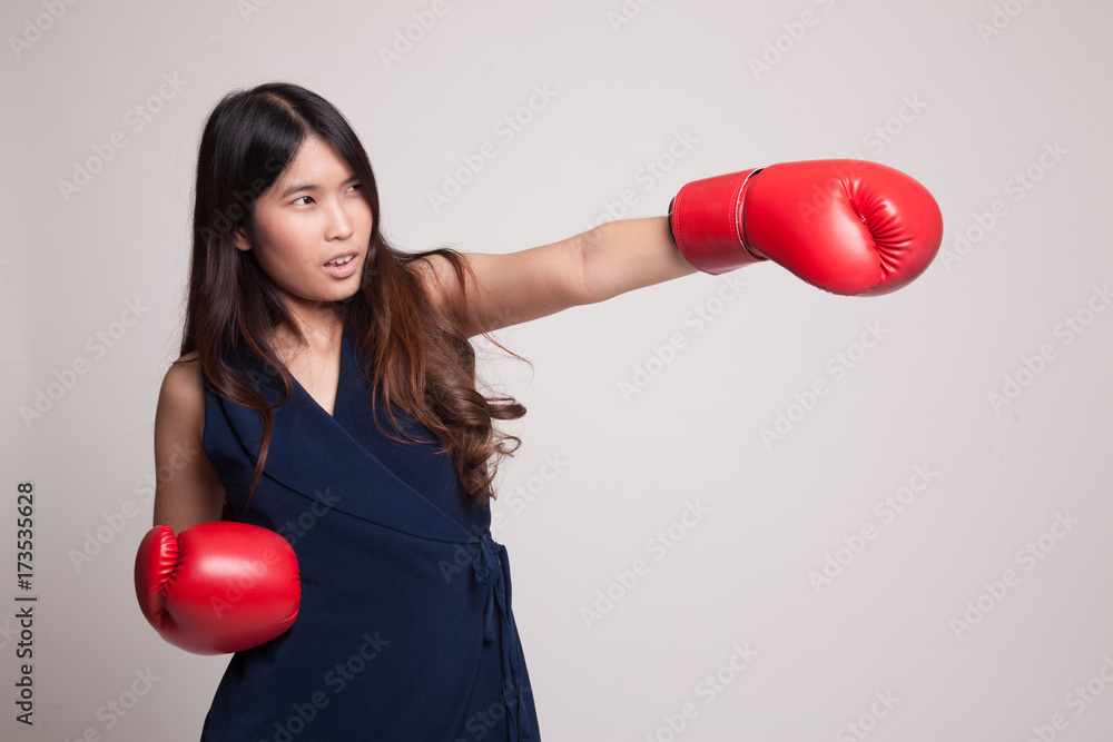 Young Asian woman with red boxing gloves. Young Asian woman with red boxing gloves.