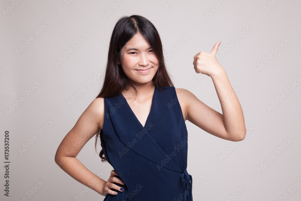Young Asian woman show thumbs up. Young Asian woman show thumbs up.