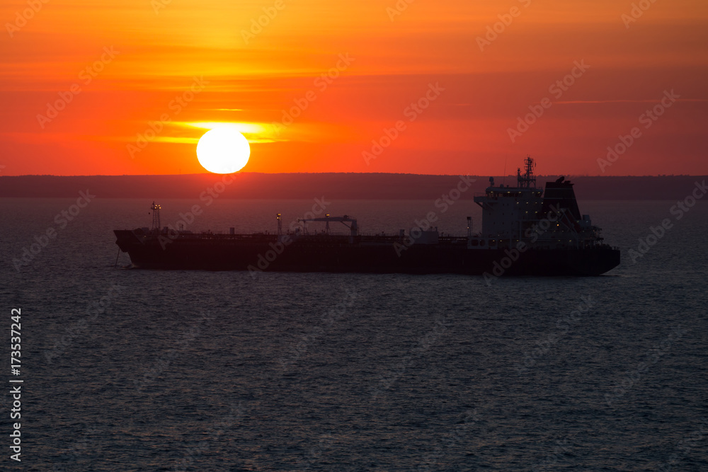 Crago ship at anchor when it sunset.