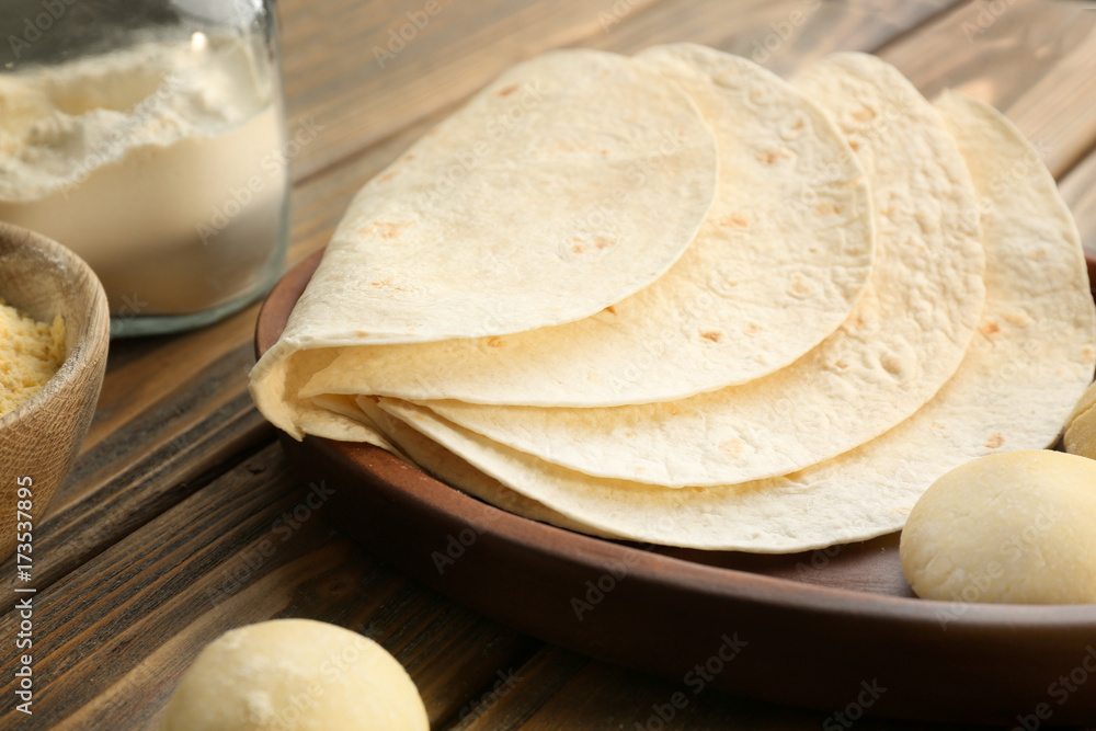 Delicious tortillas and dough balls on kitchen table Delicious tortillas and dough balls on kitchen table