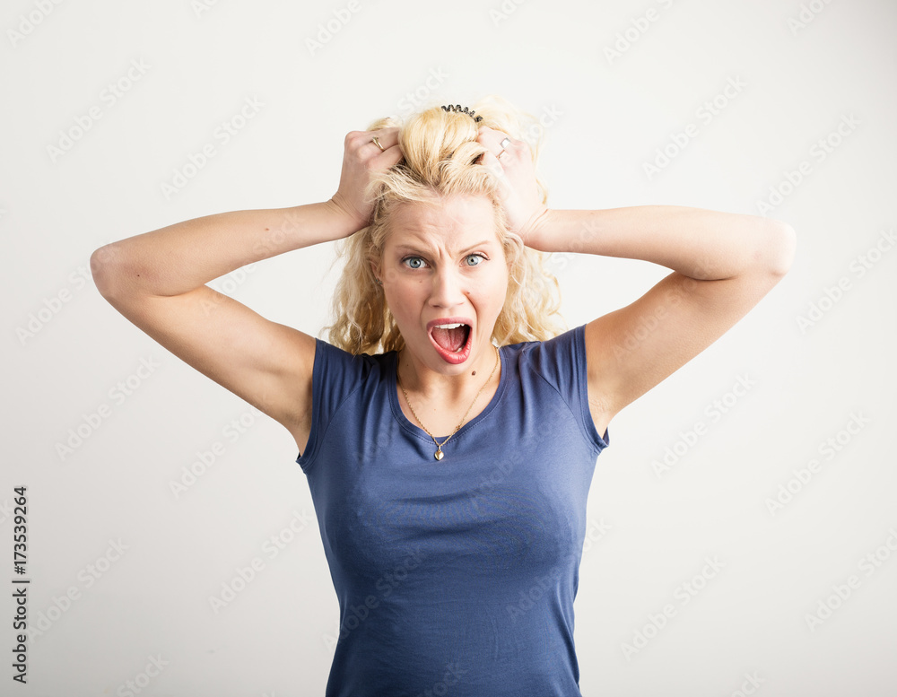 Angry woman pulling her hair out Stock Photo | Adobe Stock