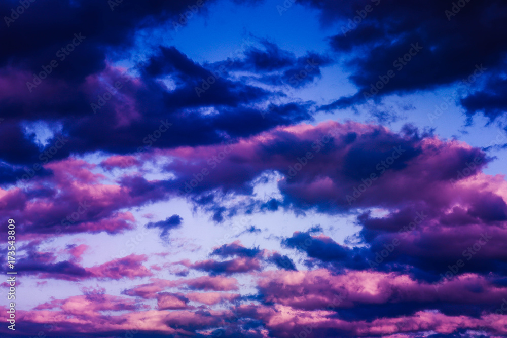 photo depicting evening sunset colored purple and blue cloudy misty sky. Stormy sunrise overcast weather.