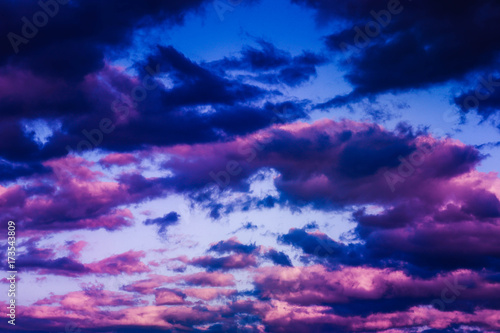 photo depicting evening sunset colored purple and blue cloudy misty sky. Stormy sunrise overcast weather. © alicefoxartbox