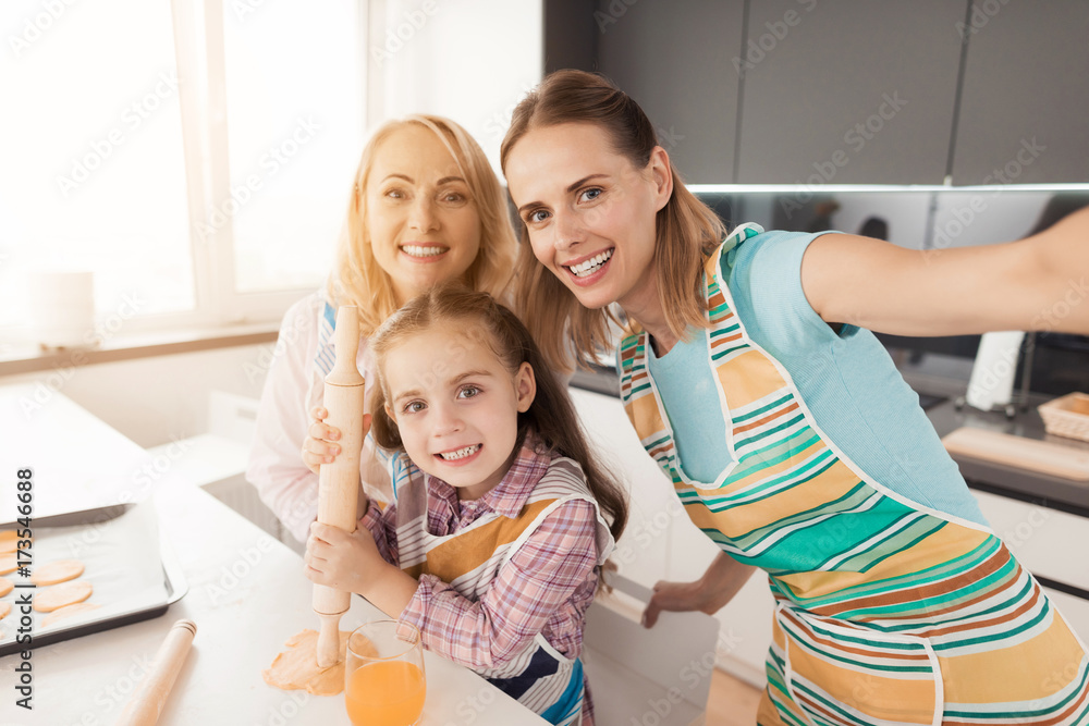 Family makes selfies for Thanksgiving in the kitchen while cooking food Family makes selfies for Thanksgiving in the kitchen while cooking food