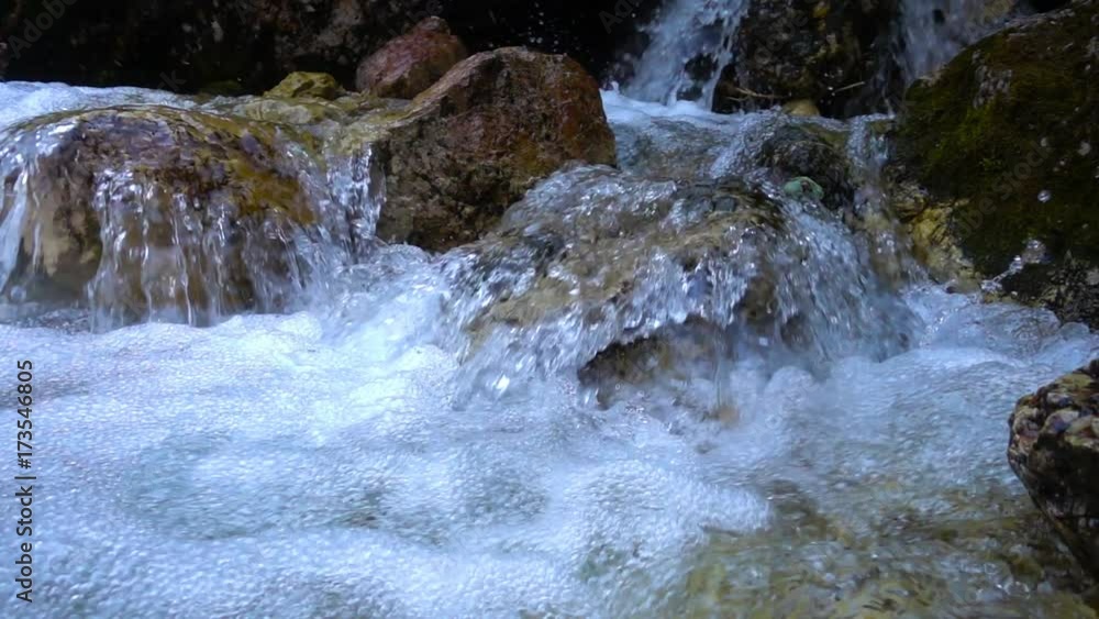 SLOW MOTION: flowing water over stones in mountines river SLOW MOTION: flowing water over stones in mountines river