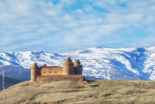 Castle Calahorra with the snow capped mountains of the Sierra Nevada, Granada Province, Andalusia, Spain.