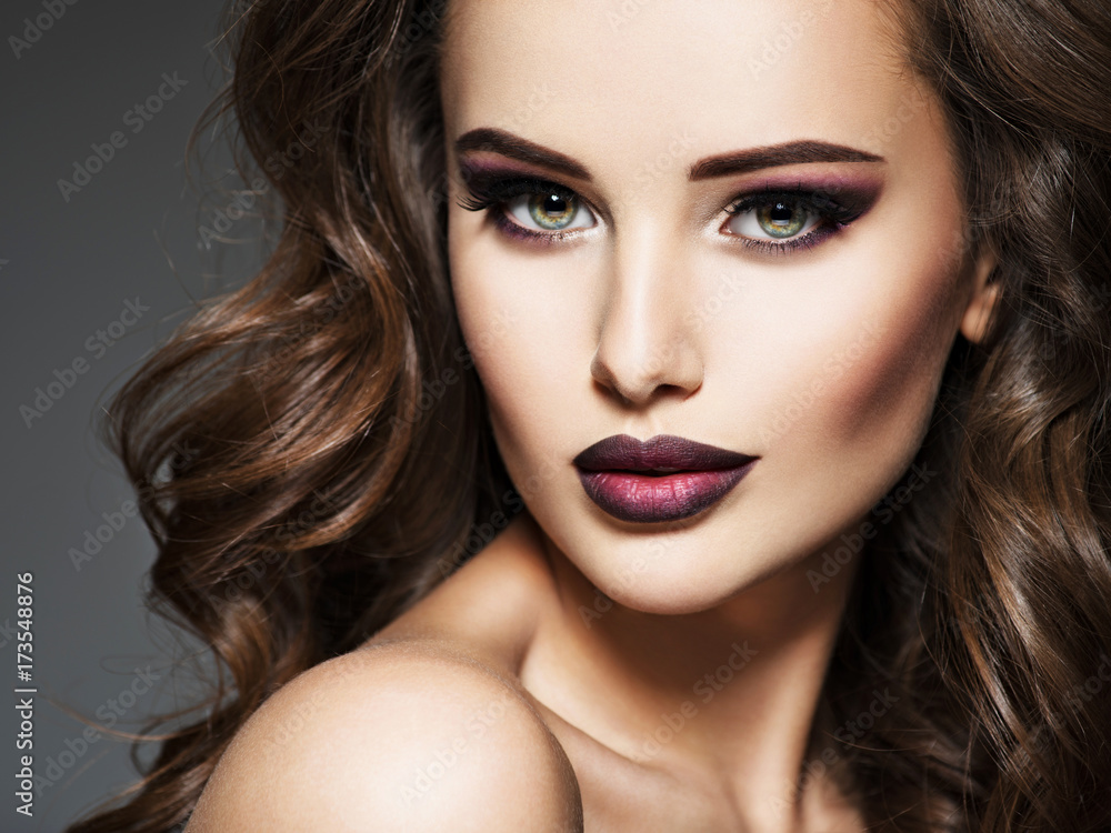 Fototapeta premium Beautiful face of an young woman with brown hair.