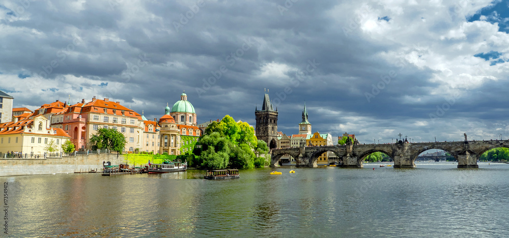 Landscape of the romantic city of Prague under a blue sky. Panoramic view of Charles bridge and old town on a summer day in the capital Czech Republic. Cruise on the Moldovan river.