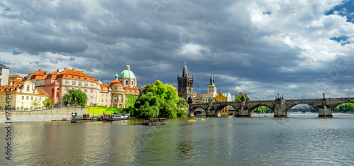 Landscape of the romantic city of Prague under a blue sky. Panoramic view of Charles bridge and old town on a summer day in the capital Czech Republic. Cruise on the Moldovan river.
