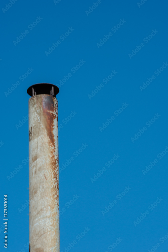 Smoke Stack against bright blue sky