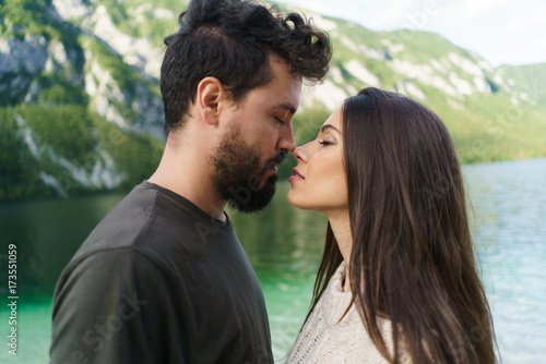 Couple kissing at lake photo