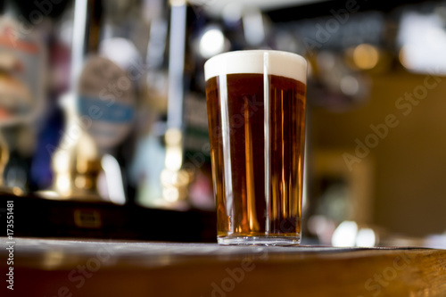 Pint of real ale on a bar in an English pub photo