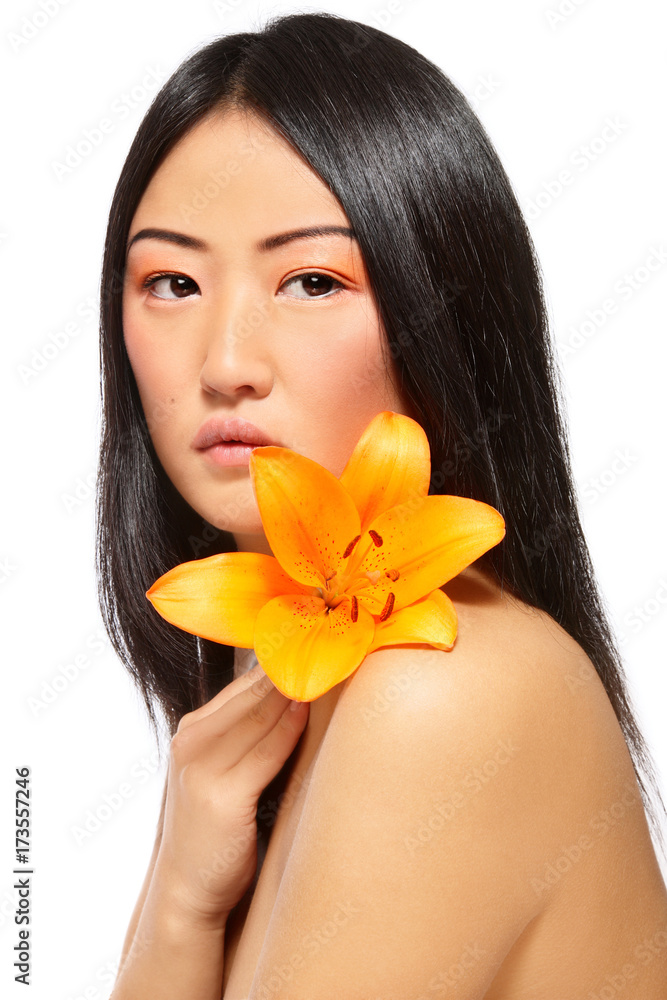 Young beautiful asian girl with bright flower in hand over white background, copy space Young beautiful asian girl with bright flower in hand over white background, copy space
