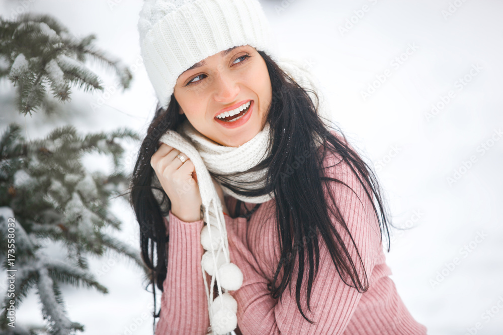 Pretty cheerful young woman outdoors. Young beautiful girl in the winter wood smiling at camera. Close up portrait of pretty woman outside in the winter Pretty cheerful young woman outdoors. Young beautiful girl in the winter wood smiling at camera. Close up portrait of pretty woman outside in the winter