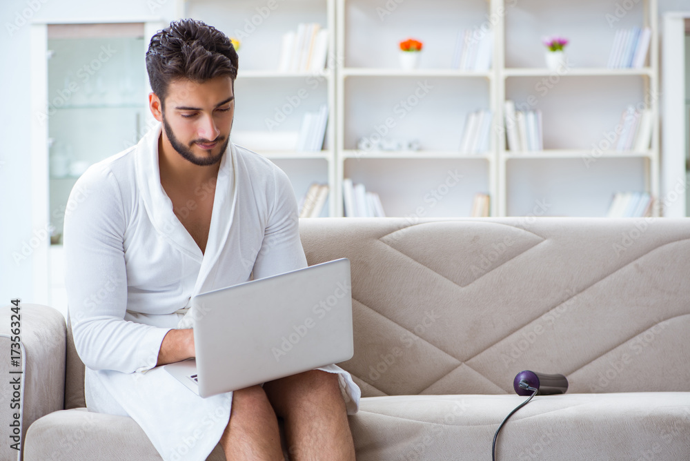Young man freelancer working from home on a laptop Young man freelancer working from home on a laptop