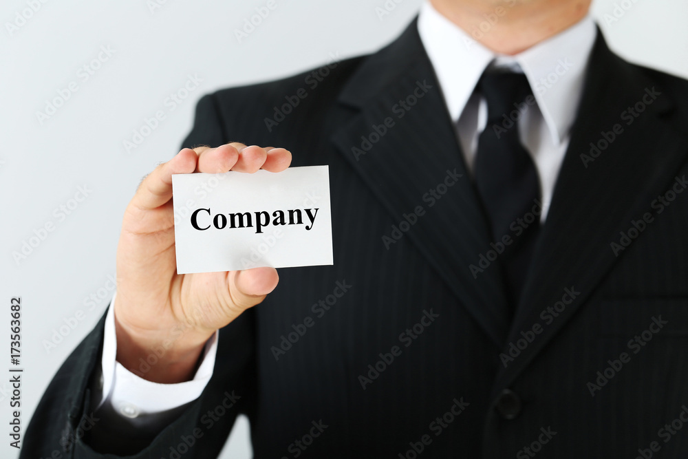 Businessman holding card with word Company Businessman holding card with word Company