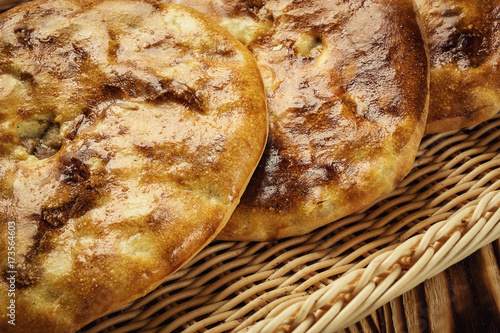 bakery product kubdari in Georgian,traditional georgian baked food kubdari on wooden table; delicious bakery cuisine of caucasus;kubdari meat photo