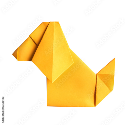 Yellow folded paper origami sitting cartoon dog on white background iso;ated. Empty space for copy, text, lettering.