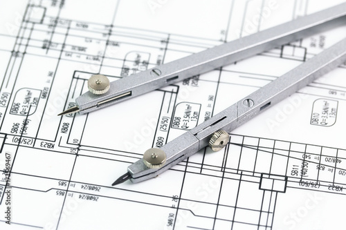 architectural background with plan, blueprint roll and drawing compass 