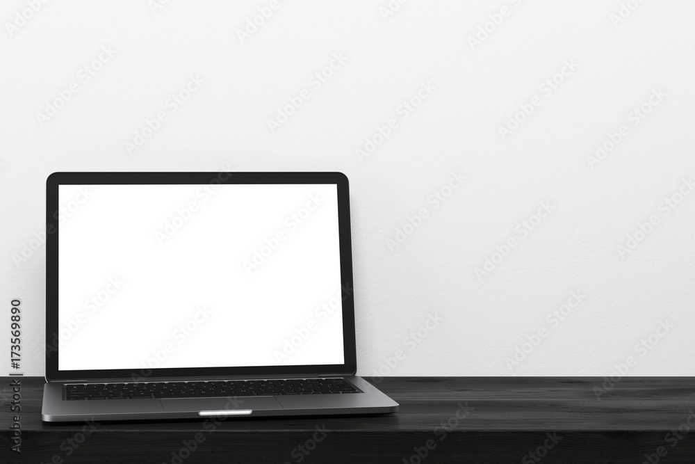 Laptop on a black wooden table, white wall Laptop on a black wooden table, white wall