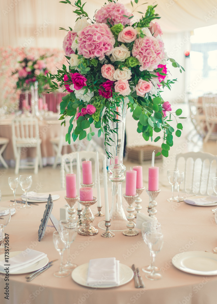 a reflective table at a wedding banquet, a table with candles, flowers and a beautiful tableware a reflective table at a wedding banquet, a table with candles, flowers and a beautiful tableware