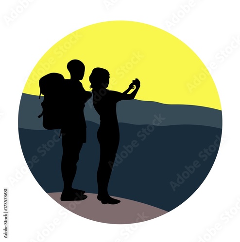 Couple - young man and woman - walking on a mountain trail and looking at a horizon, taking a photo pic.