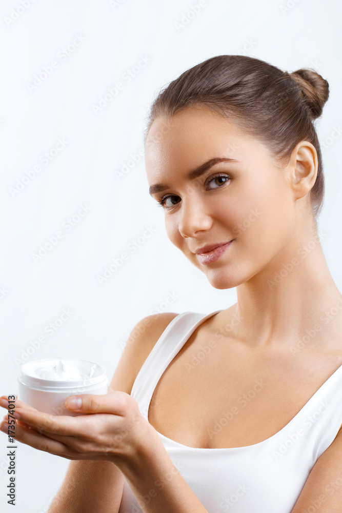 Woman Face Skin Care.Portrait of attractive Young Female With Hand Holding Cosmetic Cream. Female with fresh makeup and Perfect Skin..Natural Makeup.Beauty Concept Woman Face Skin Care.Portrait of attractive Young Female With Hand Holding Cosmetic Cream. Female with fresh makeup and Perfect Skin..Natural Makeup.Beauty Concept