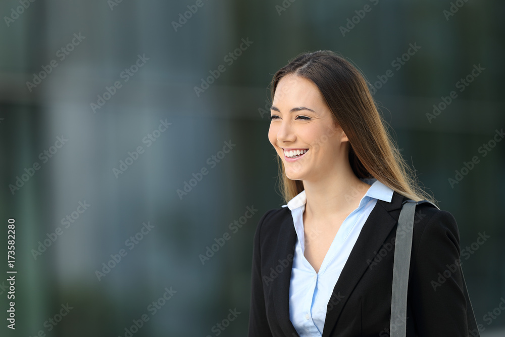 Happy executive walking on the street Happy executive walking on the street