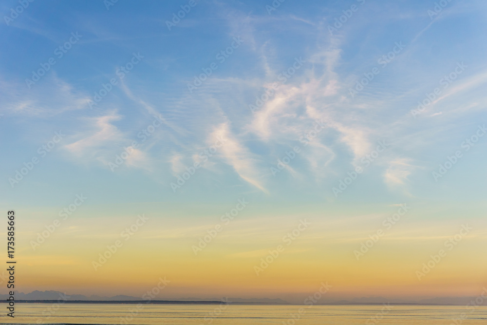 background of small clouds in sunset sky over the ocean.