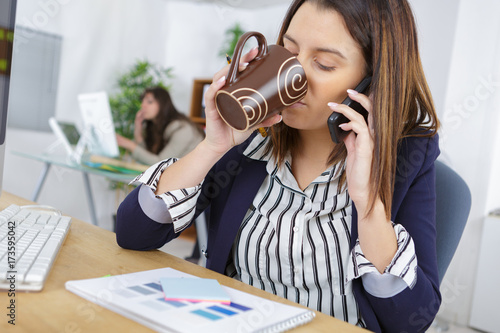 woman multi-tasking in the office photo