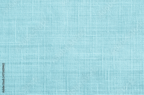 Jute hessian sackcloth canvas sack cloth woven texture pattern background in teal cyan blue color