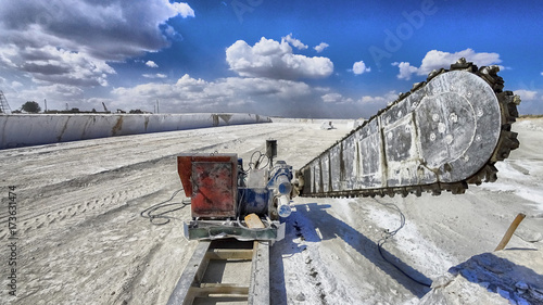 Industrial shot illustrating the production of marble. Cutting the rock at the quarry by a giant saw. photo