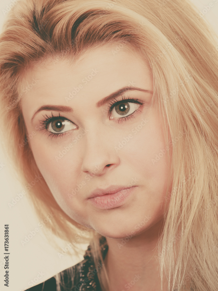 Portrait of blonde woman with serious face expression Portrait of blonde woman with serious face expression