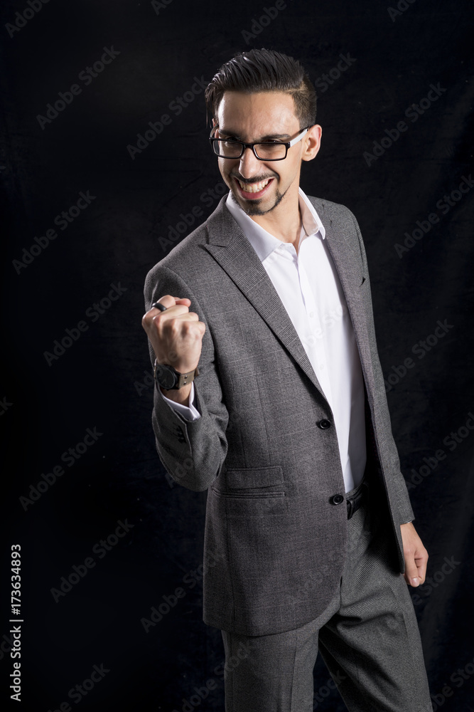 Man in Business Suit Clenches Fist in Delight Man in Business Suit Clenches Fist in Delight
