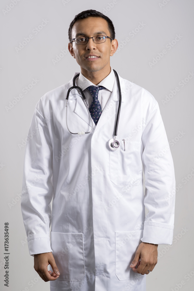 Male Doctor with Stethoscope Around Neck Over a Gray Background Male Doctor with Stethoscope Around Neck Over a Gray Background