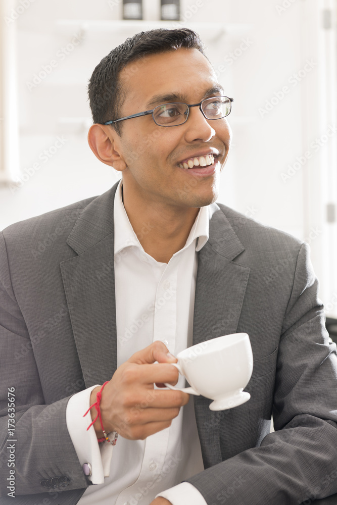 Guy in Business Attire Holding Tea Cup Smiling While Looking Away Guy in Business Attire Holding Tea Cup Smiling While Looking Away