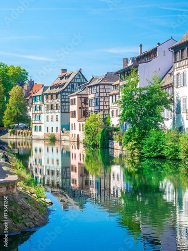 Typical house near water and flowers from La Petite France in Strasbourg, Alsace, France