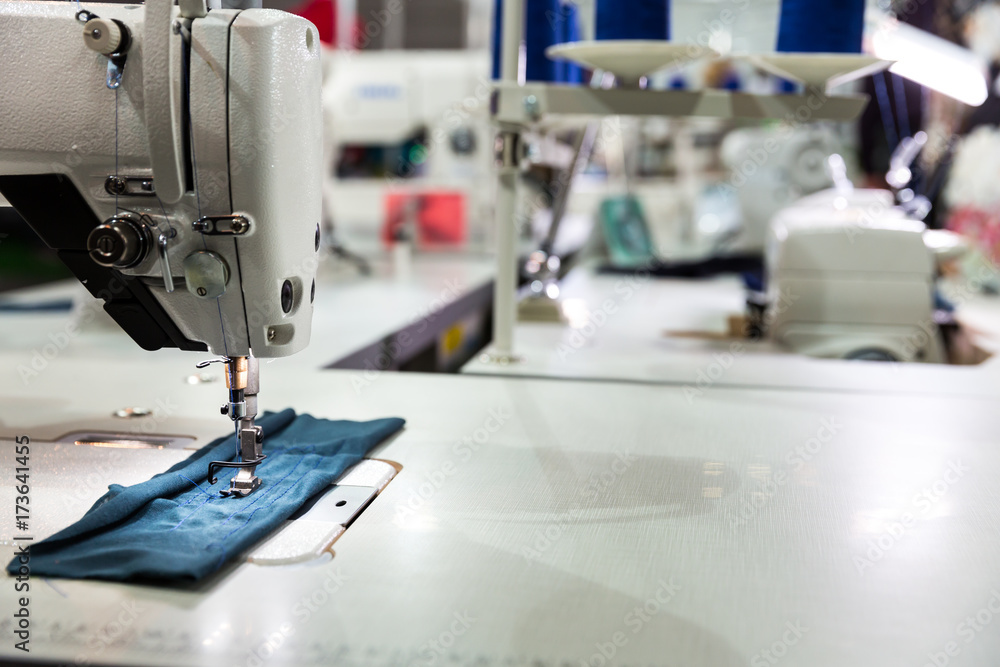 Sewing machine on textile fabric closeup, nobody
