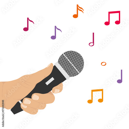 The hand holds the microphone