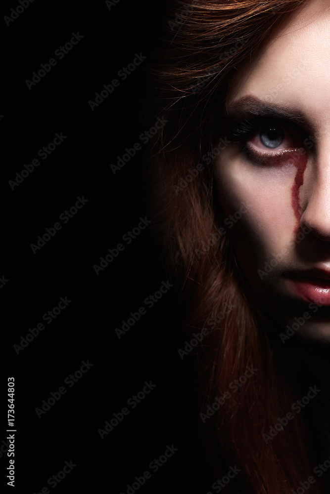 bloody woman face in the dark