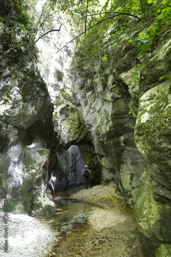 hiker in narrow gorge canyon at matese park valle del torano photo