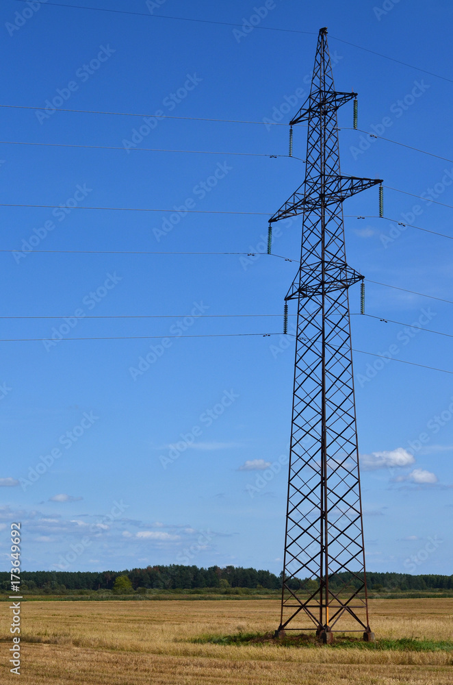 High voltage power line. Electric tower in a field