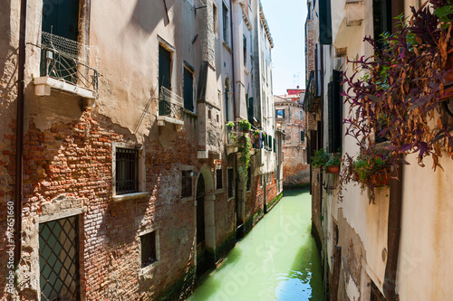 Scenic canal with ancient buildings in Venice, Italy.