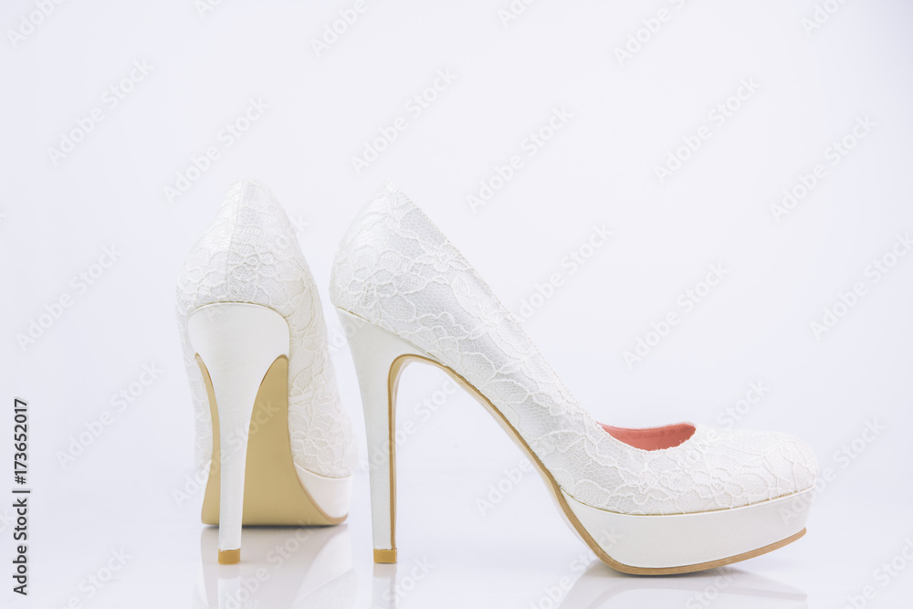 Obraz premium Two Bridal High Heel Shoes On White Background With Reflection