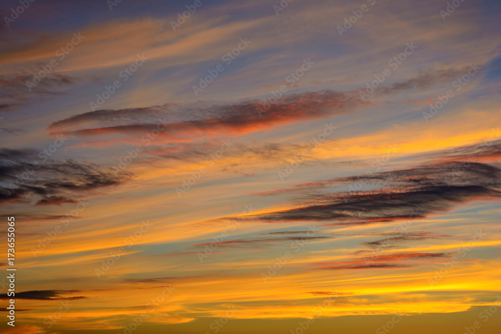 Photo of orange sunset with dark clouds on sky