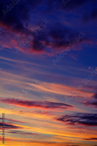 Photo of orange sunset with dark clouds on sky