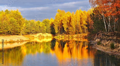 bright, rich colors of autumn foliage reflected in the lake