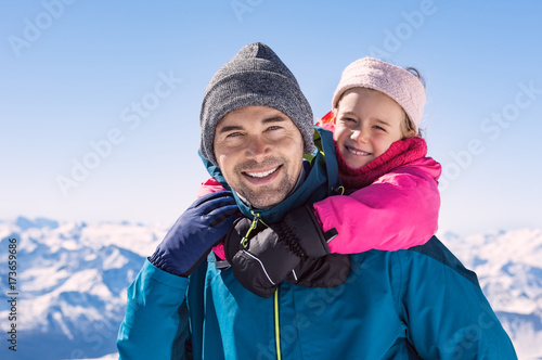 Father and daughter enjoy the snow