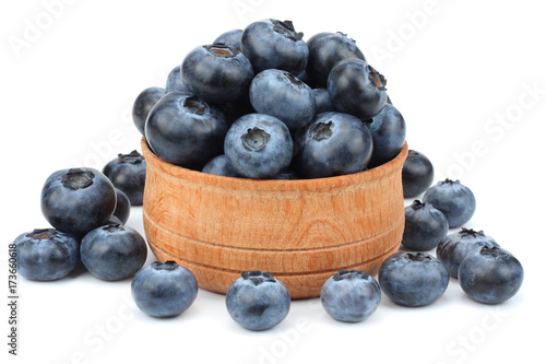 blueberries in wooden bowl isolated on white background